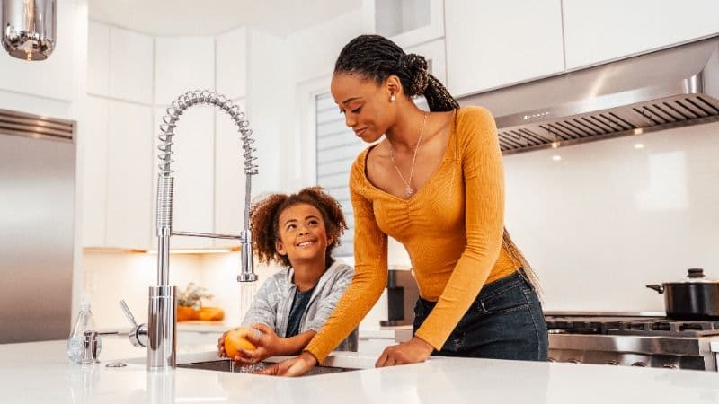 Two people standing at the sink