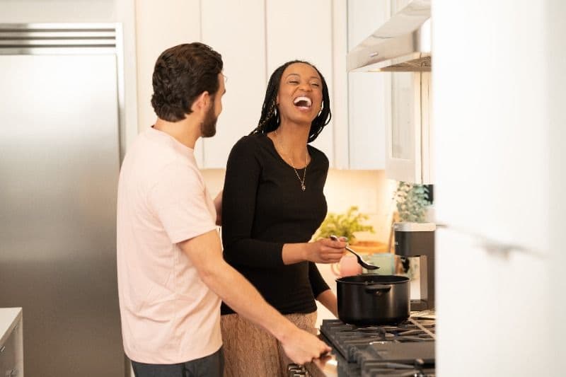 Couple laughing in a kitchen